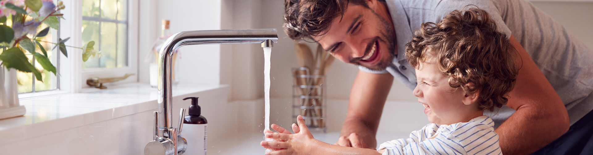 man and child washing hands