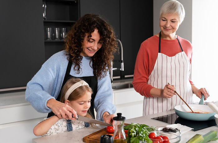daughter, mother and grandmother cooking together